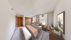 Greenfield apartment for rent - A bedroom with a large bed and a painting on the wall.