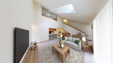 Greenfield apartment for rent - A living room with a grey couch and a wooden coffee table.