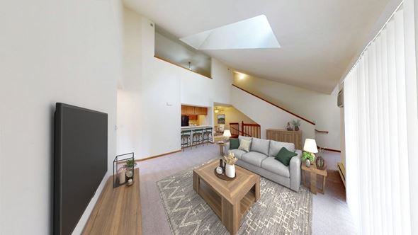 Greenfield apartment for rent - A living room with a grey couch and a wooden coffee table.