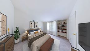 New Berlin townhouse for rent - A bedroom with a large bed and a television.
