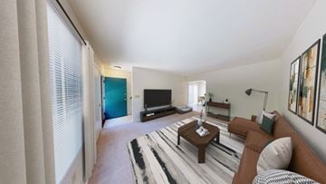 New Berlin townhouse for rent - A living room with a brown couch and a television.