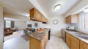 Hales Corners townhouse for rent - A kitchen with a brown counter top and a clock on the wall.