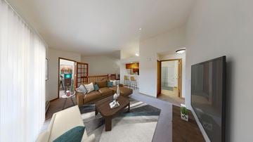 Hales Corners apartment for rent - A living room with a brown couch and a television.