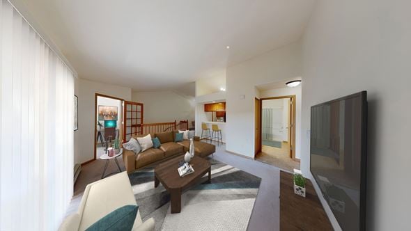 Hales Corners apartment for rent - A living room with a brown couch and a television.