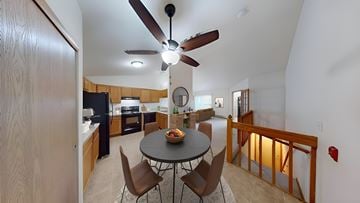 Hales Corners apartment for rent - A kitchen with a table and chairs in the middle of the room.