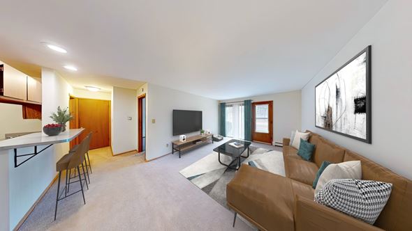 New Berlin apartment for rent - A living room with a brown couch and a television.