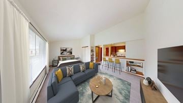 West Allis apartment for rent - A living room with a grey couch and a coffee table.