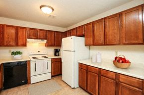 Greenfield apartment for rent - a kitchen with white appliances and wooden cabinets