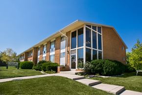 West Allis apartment for rent - the front of a brick building with large glass windows