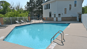 New Berlin apartment for rent - a swimming pool with a house in the background