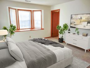 New Berlin apartment for rent - a bedroom with a bed and a large window