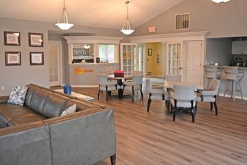 Oak Creek apartment for rent - A living room with a grey couch and a yellow door.
