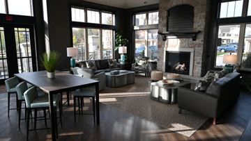 Menomonee Falls apartment for rent - a living room with couches and a table and a fireplace