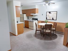 West Allis apartment for rent - a dining room with a table and a kitchen