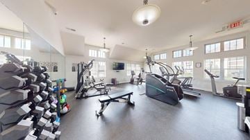 Greenfield apartment for rent - A gym with a variety of equipment including treadmills, weights, and exercise machines.
