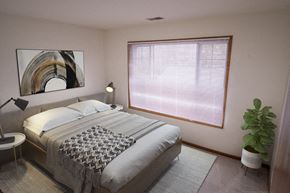 Waukesha apartment for rent - A bedroom with a large bed and a painting on the wall.