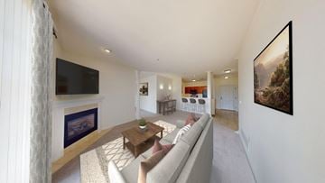 Brookfield townhouse for rent - A living room with a grey couch and a flat screen TV mounted on the wall.