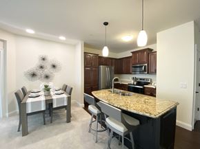 Brookfield apartment for rent - an open kitchen and dining room with a marble counter top