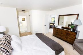 Oak Creek apartment for rent - a bedroom with a bed and a dresser and a mirror