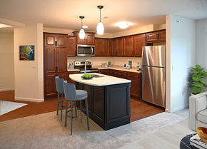 Hales Corners apartment for rent - a kitchen with a center island and a stainless steel refrigerator