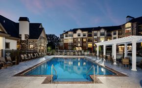 Brookfield apartment for rent - a swimming pool in front of an apartment building at night