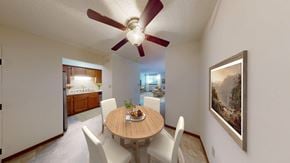 Pewaukee apartment for rent - A dining room with a table set for two and a painting on the wall.