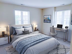 Greenfield apartment for rent - a bedroom with a bed and a desk with a laptop