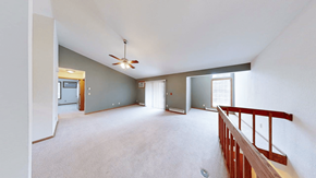 Pewaukee apartment for rent - A spacious room with a ceiling fan and a balcony.