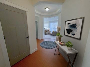 Menomonee Falls apartment for rent - a hallway with a door to a living room and a painting on the wall