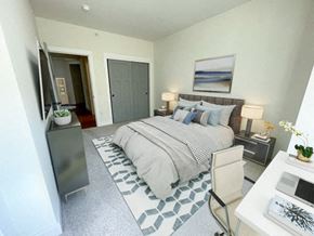 Menomonee Falls apartment for rent - a bedroom with a bed and a dresser and a tv