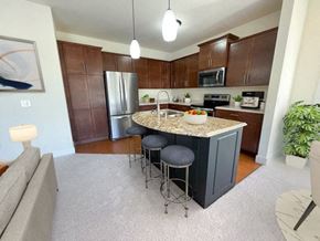 Menomonee Falls apartment for rent - a kitchen with a center island with three stools