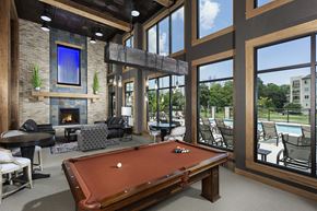 Menomonee Falls apartment for rent - a clubhouse with a pool table and a fireplace
