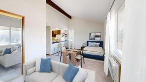 West Allis apartment for rent - a living room with a couch and a chair and a bedroom with a bed