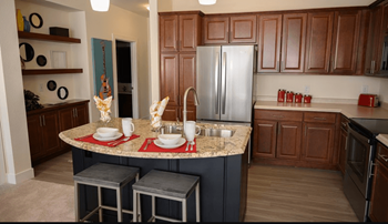 Kitchen with a large island with a granite countertop