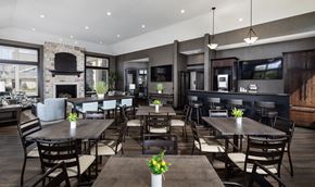Menomonee Falls apartment for rent - a large dining room with tables and chairs and a fireplace