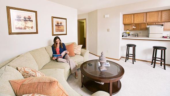 Hales Corners apartment for rent - a woman sitting on a couch in a living room