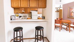 Hales Corners apartment for rent - a kitchen with two bar stools and a counter top