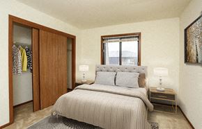 Greenfield apartment for rent - a bedroom with a bed and closet and a window