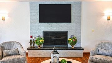 Brookfield apartment for rent - a living room with a fireplace and a tv on the wall