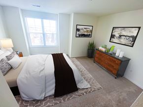 Brookfield apartment for rent - a bedroom with a large bed and a dresser