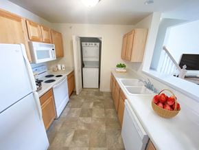 Brookfield apartment for rent - a kitchen with white appliances and wooden cabinets