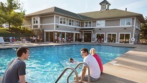 Brookfield apartment for rent - a group of people sitting at a pool with a building in the background