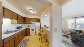 West Allis apartment for rent - A kitchen with wooden cabinets and a white refrigerator.