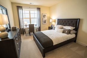 Menomonee Falls apartment for rent - a bedroom with a bed and a desk and a window
