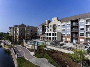 Menomonee Falls apartment for rent - an exterior view of an apartment building with a swimming pool