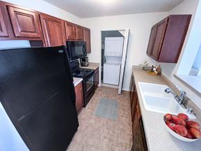 Brookfield apartment for rent - a kitchen with a black refrigerator freezer next to a sink