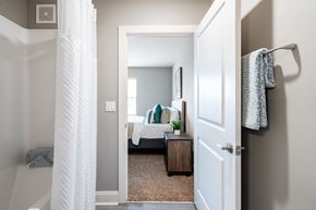 Cocoa apartment for rent - A white door is open to a bedroom with a bed and a nightstand.