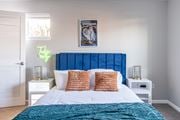 Canandaigua apartment for rent - A bedroom with a large bed and a blue headboard at Centerpointe Apartments, Canandaigua, NY