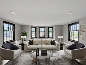 Buffalo apartment for rent - A modern living room with a large sofa, two chairs, and a coffee table.