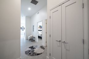 Buffalo apartment for rent - A hallway with a rug and a bedroom with a bed and a dresser.at The Annex Apartment, Buffalo, NY